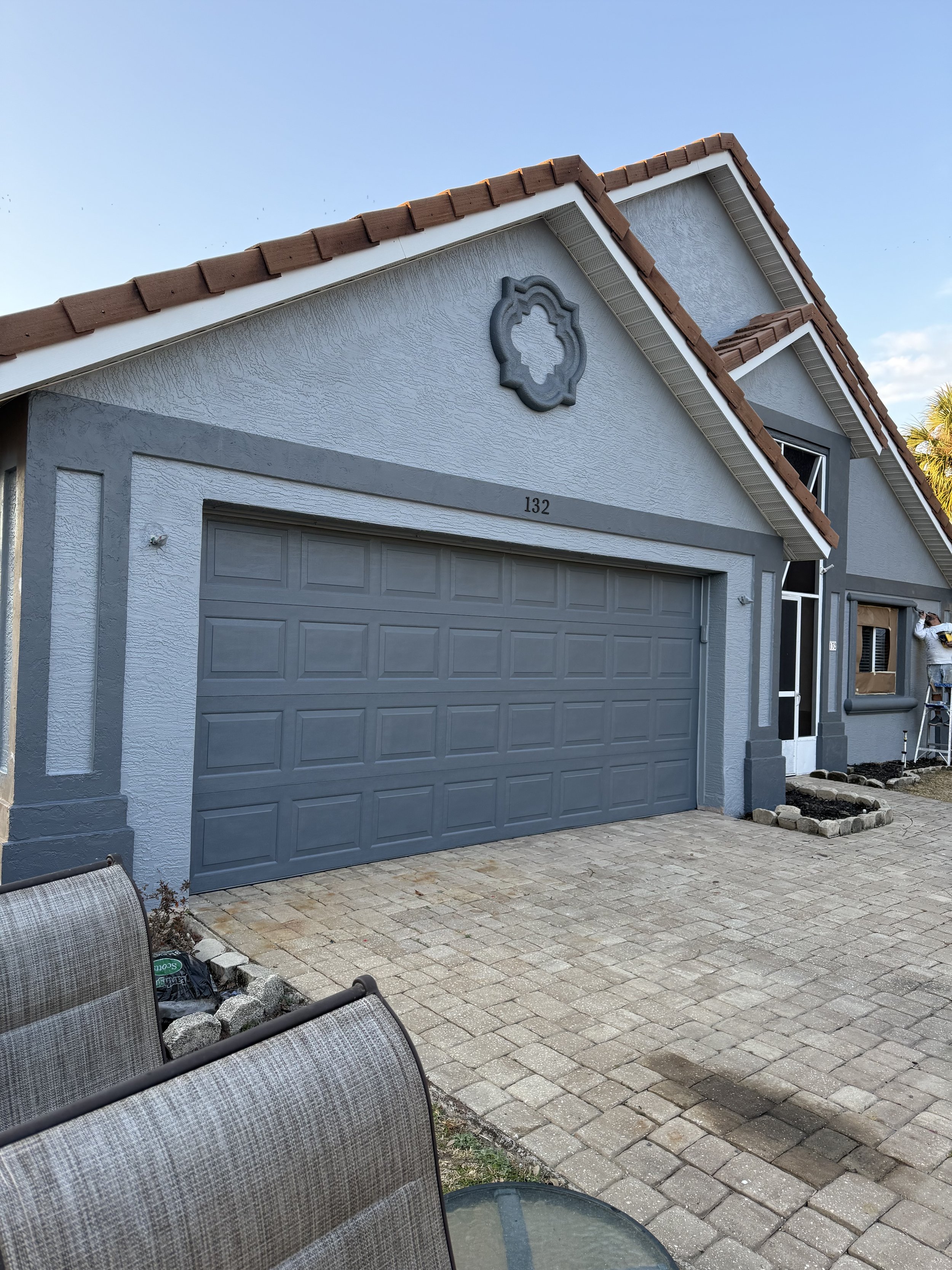 Hopkins Painting crew member painting exterior trim on a Palm Coast home