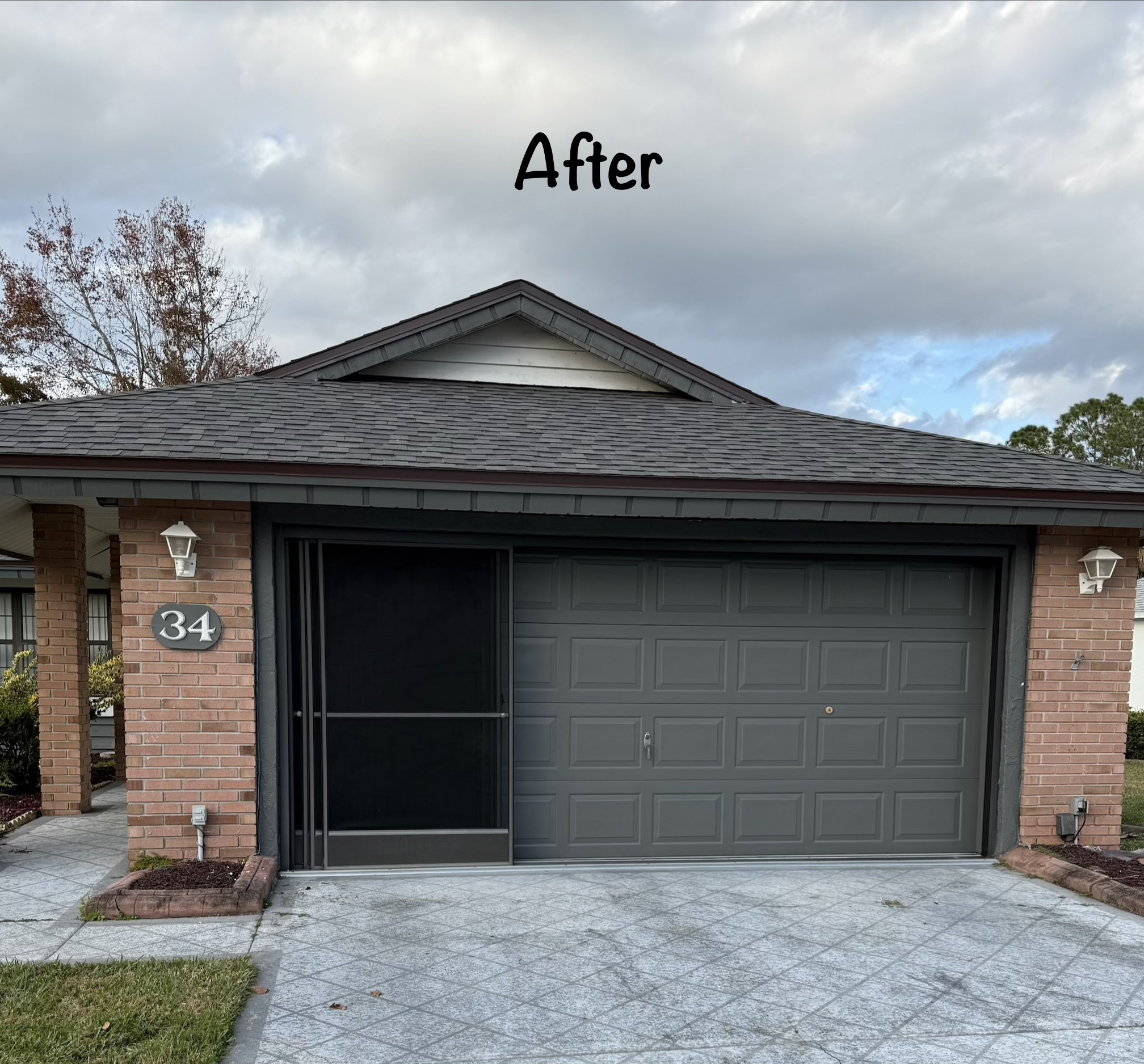 Same garage exterior after repainting in a fresh dark grey